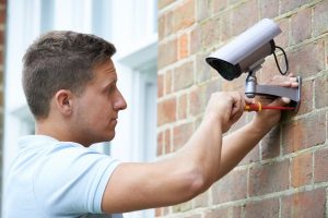 depositphotos 76066841 stock photo security consultant fitting security camera