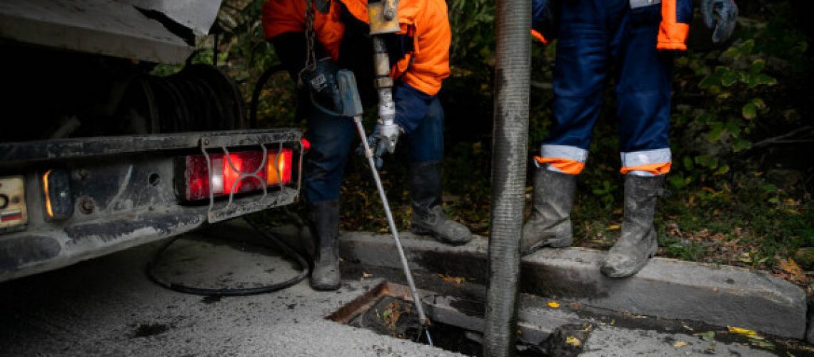 depositphotos_411564768-stock-photo-cleaning-storm-drains-debris-clogged
